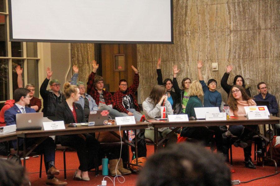 Members of the LGBTQIA+ community raise their hands for recognition during their sit in protest of Student Governments Senate File 274 during the Student Government meeting on March 6 at the Memorial Union. 