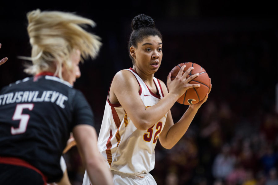 Forward Meredith Burkhall looks for an open pass during the Iowa State vs Texas Tech womens basketball game Jan. 29 in Hilton Coliseum. The Cyclones defeated the Red Raiders 105-66.