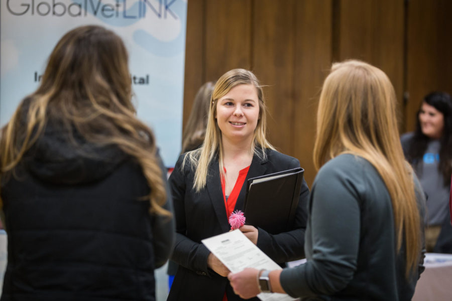 A student hands her resume out at the College of Agriculture and Life Sciences Career Fair held Feb. 6 in the Great Hall of the Memorial Union. 