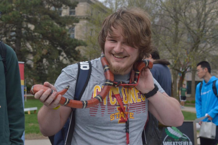 Ian Crowl, a junior in aerospace engineering, smiles with a snake at the Earth Day Celebration. Booths at the event had many different things for students to do and hear to learn about conservation and sustainable living. The event was held Thursday on the South side lawn in front of Parks Library and had many booths promoting sustainable living.