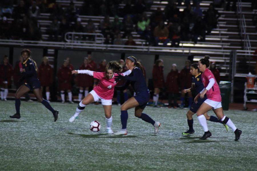 Senior Emily Steil captures the ball away from West Virginia while wearing pink for breast cancer awareness on Oct. 12 at the Cyclone Sports Complex.