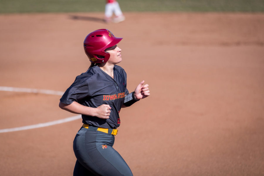 Iowa State senior Sally Woolpert jogs to first after getting four balls from the South Dakota pitcher during the Iowa State vs South Dakota softball game held at the Cyclone Sports Complex April 2. The Cyclones had three home run hits and defeated the Coyotes 9-1.
