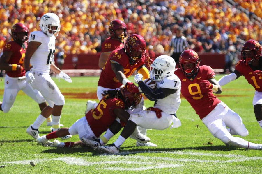 Defensive back Datrone Young (right) and linebacker O’Rien Vance (middle), take down running back Van Edwards Jr. of University of Akron during their game at Jack Trice Stadium on Sept. 22, 2018. The Cyclones won 26-13.