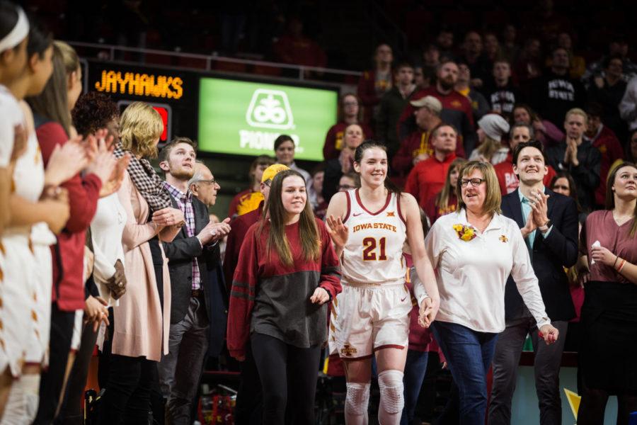 Iowa State senior guard Bridget Carleton walks to center court with her family following the Iowa State vs Kansas Senior Night basketball game held in Hilton Coliseum. The Cyclones defeated the Jayhawks 69-49.