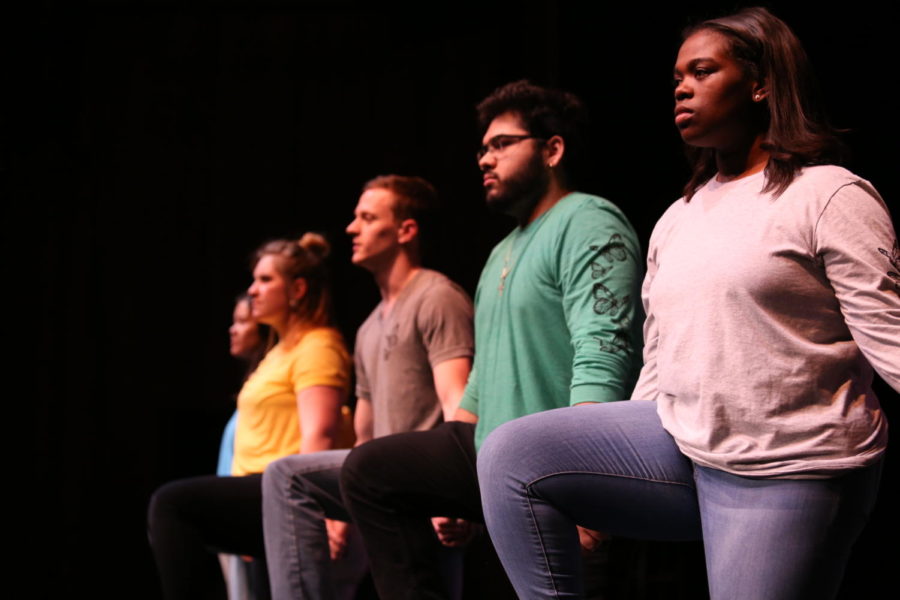 Members of the Iowa Odyssey cast take a knee during their dress rehearsal Wednesday April 24. The play is about how the idea of immigration is connected to our community’s past and present. Performances are April 26, 27, and 28 and May 3, 4, and 5 in Fisher theater.