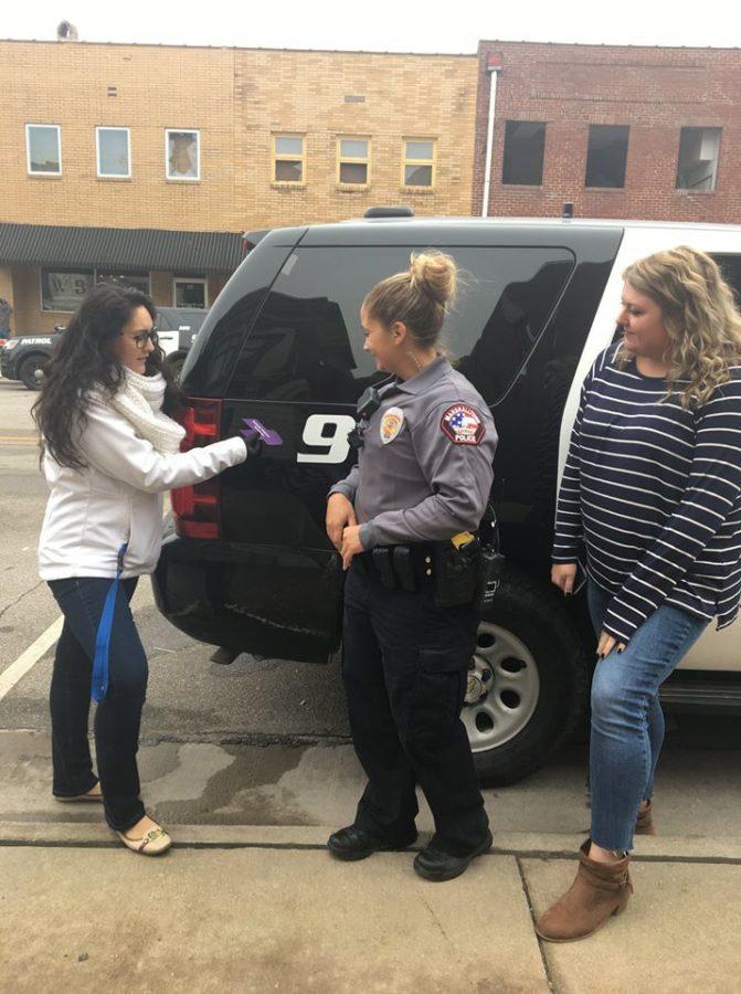 ACCESS advocates were placing purple ribbons onto Marshalltown Police Departments vehicles to raise awareness for Domestic Violence Awareness Month, which is during the month of October. 