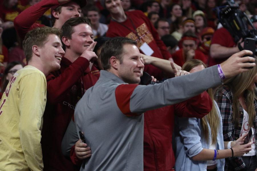 Former Iowa State head coach Fred Hoiberg takes time to take photos with students at the Cyclones game against Baylor on Feb. 19.