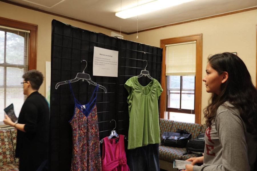 Freshman Maribel Barrera looks at some of the clothing recreations at the What Were You Wearing? event at the Margaret Sloss House on April 9. The exhibit was created to combat victim-blaming.
