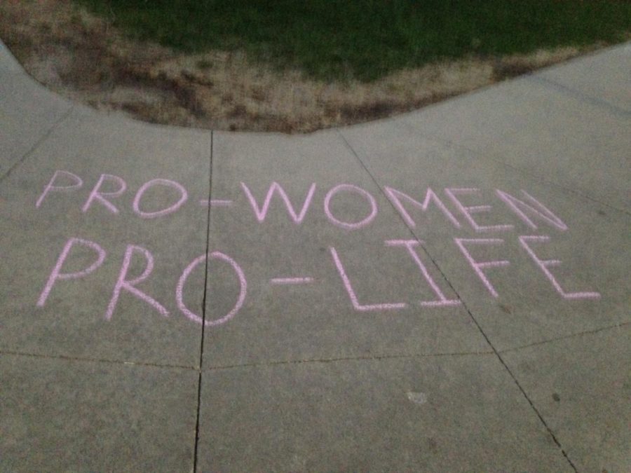 Pro-life messages like the one above were chalked around campus by Students for Life. The messages were soon altered to pro-choice arguments by groups disagreeing with them.