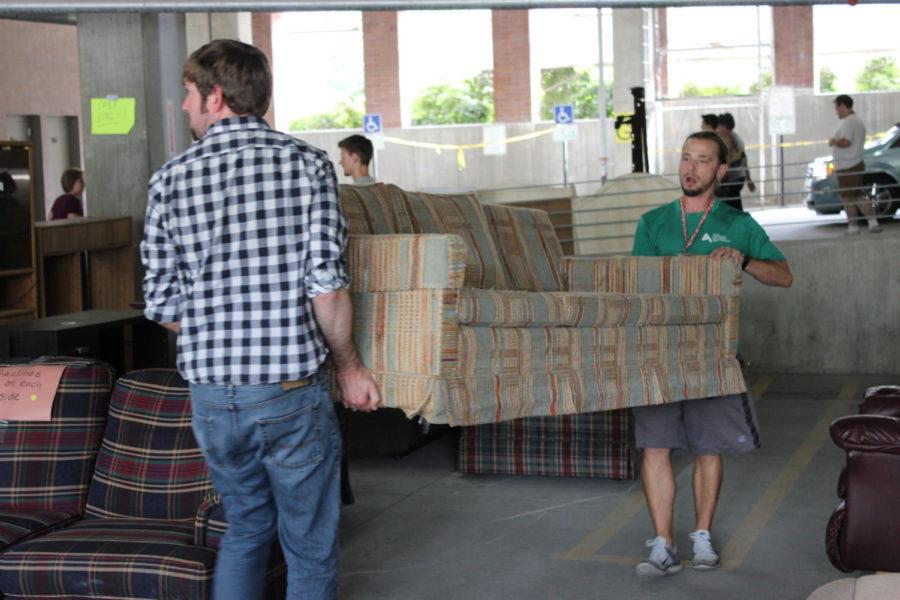 Volunteers help load couches for buyers at Rummage Rampage on July 30, 2016.