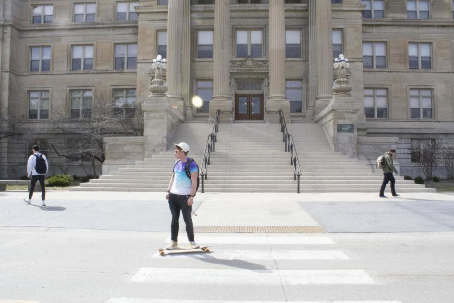 A student skateboards in front of Beardshear Hall on Monday. With the weather staying above 50 degrees this week, many students are choosing other forms of transportation and spending more time outdoors.