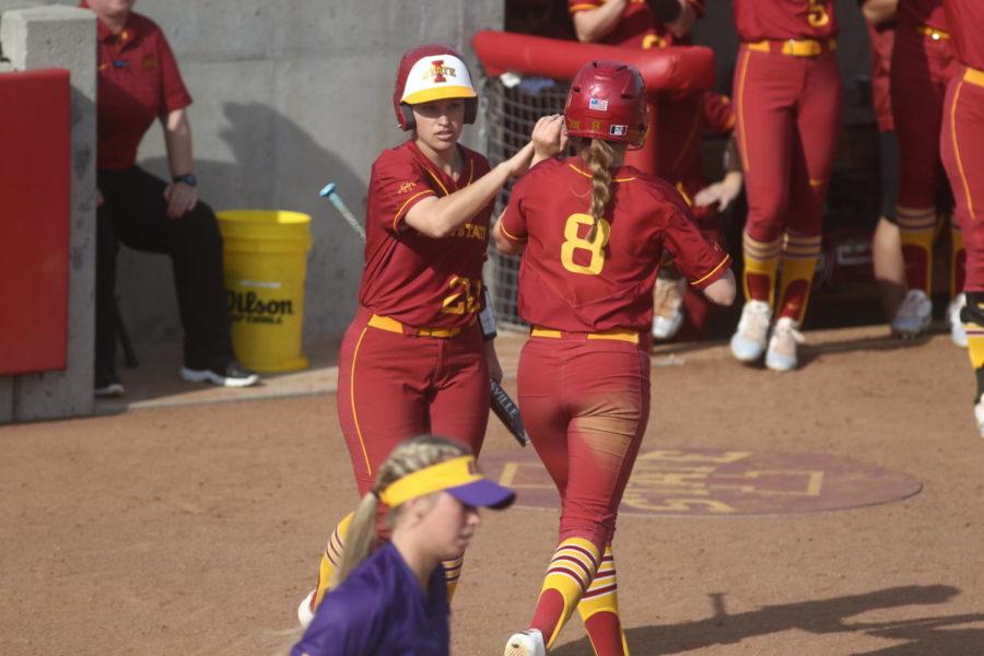 Iowa State senior Taylor Nearad is congratulated by teammate Sally Woolpert after scoring the Cyclones first run against UNI on Tuesday, April 16. Nearad scored after the Panthers pitcher dropped a pitch. The Cyclones won, 2-0.