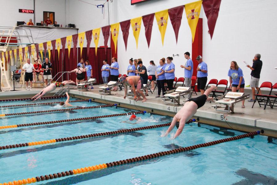 Special Olympics athletes begin the fourth heat of the 100m freestyle event at the Beyer Hall pool. 