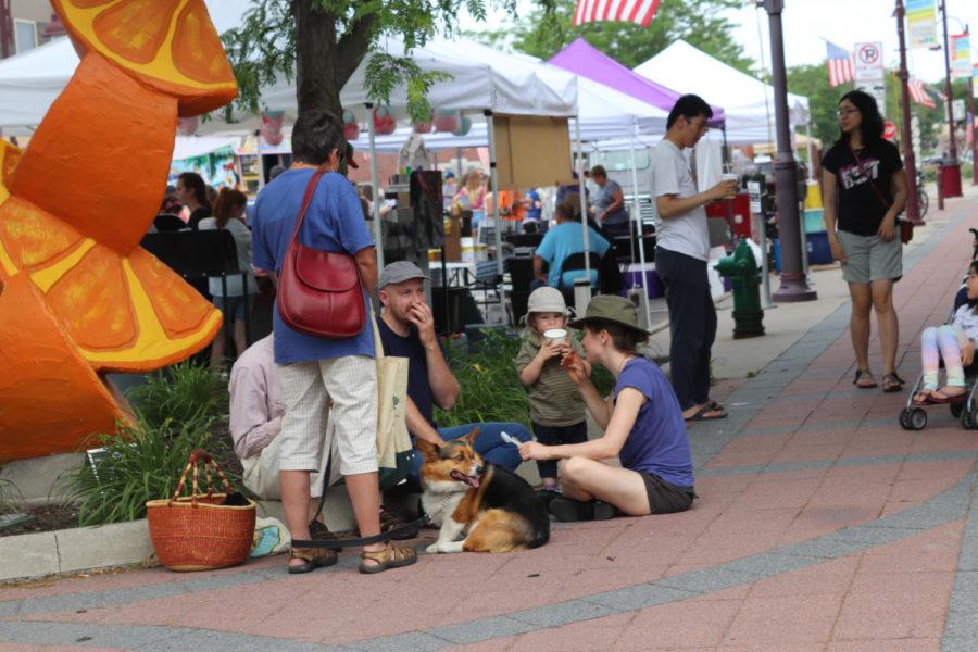 Patrons relax at the Ames Main Street Farmers Market on June 15. The Market is open every Saturday from 8 to 12:30 May through September. 