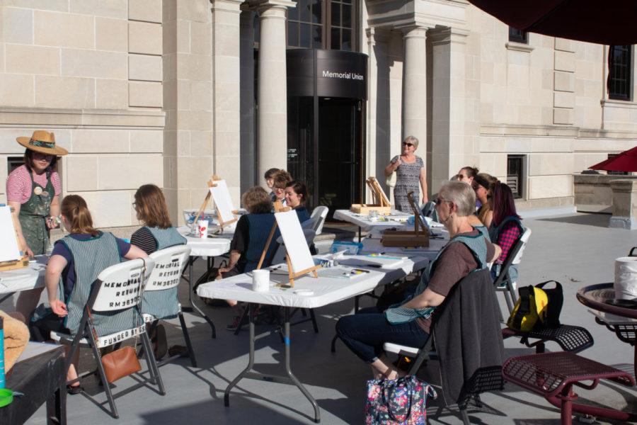 Participants of the Happy Outdoor Painting Workshop at the Memorial Union on June 25. The workshop was based on the painting style of famed television personality Bob Ross.