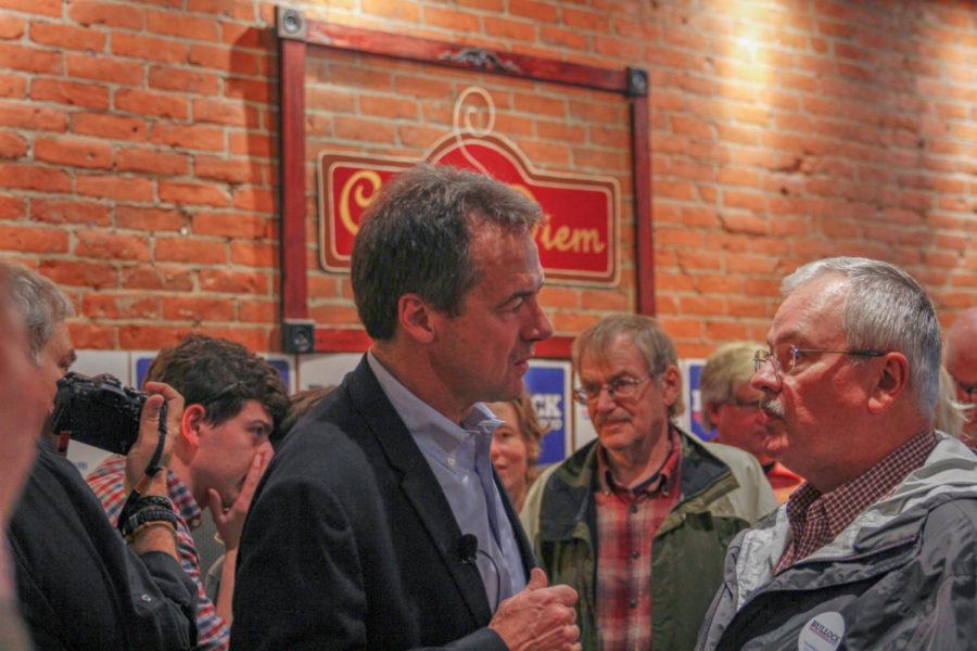 Montana governor and Democratic presidential candidate Steve Bullock talks to a supporter at Cafe Diem on May 28.