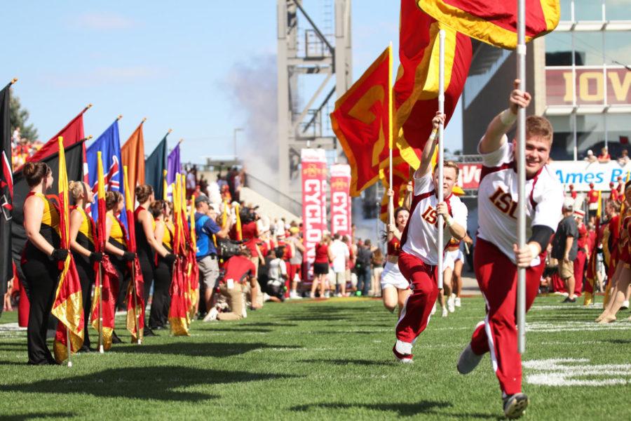 Members of the Iowa State cheerleading team run onto the field to begin the football game against the Oklahoma Sooners at Jack Trice Stadium on Sep. 15.