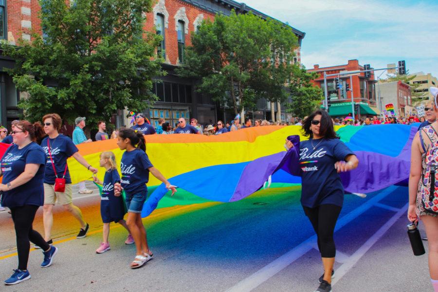 Representatives of U.S. Bank carry a large pride flag across the parade route during the Capital City Pride Fest parade in Des Moines on June 9. The parade started at the Iowa Capitol Building and traveled down Grand Avenue in the East Village. 