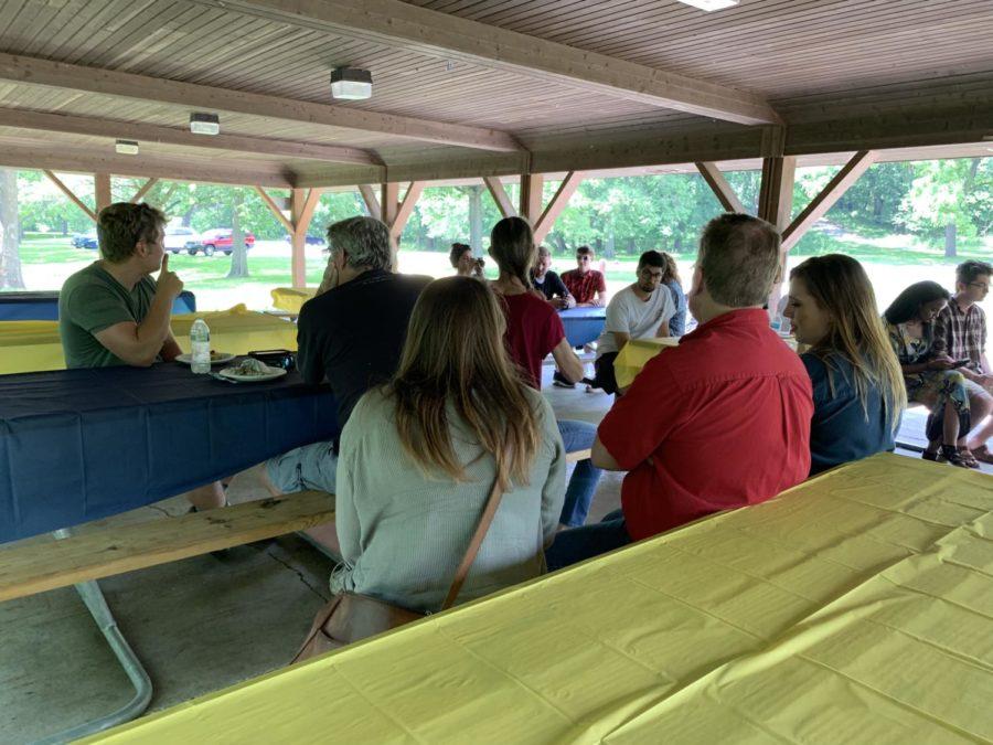 Attendees sit under the pavilion rented by Joe Van Erdewyks City Council campaign for a kickoff party at Emma McCarthy Lee Park in Ames on June 15.