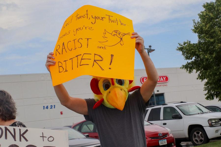 A protester wears a chicken head and holds a sign alluding to Rep. Steve Kings Twitter during the #CloseTheCamps protest. Protesters demonstrated outside Kings office on July 2 for the closing of U.S. immigrant detention centers. 