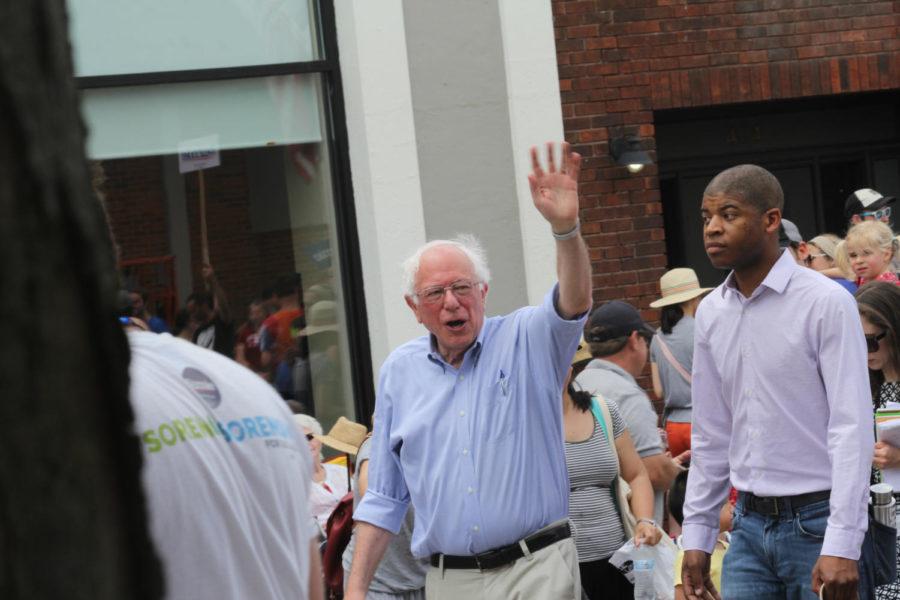Democratic presidential candidate Sen. Bernie Sanders waves to parade-goers during the City of Ames 4th of July parade. The parade featured local businesses as well as representatives from other political campaigns. 