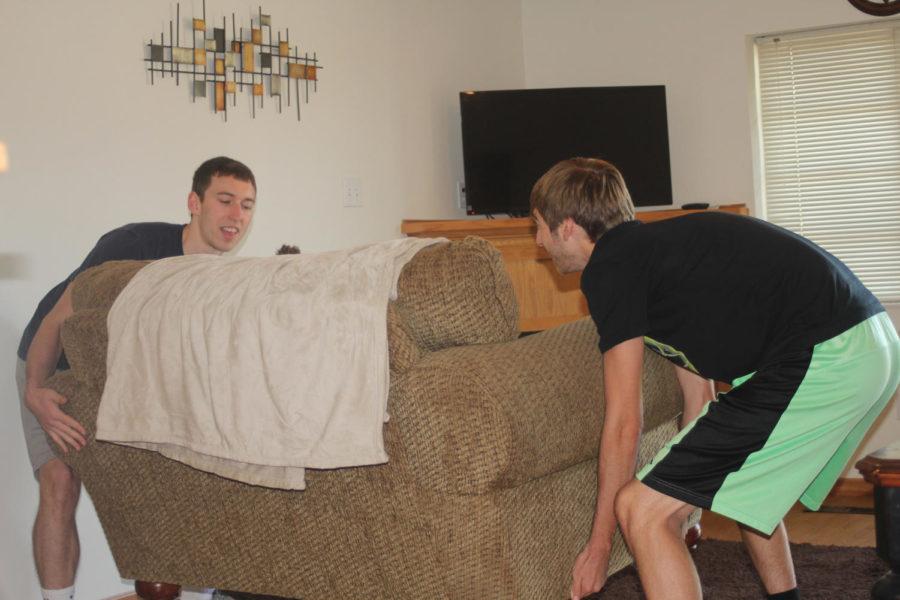 Pictured right to left: Erick Smith, Junior and Jake Starnes, Junior. Getting to work on moving in their couch for their new apartment off campus. Students choose to move off campus because it is cheaper than continuing to live in dorms.
