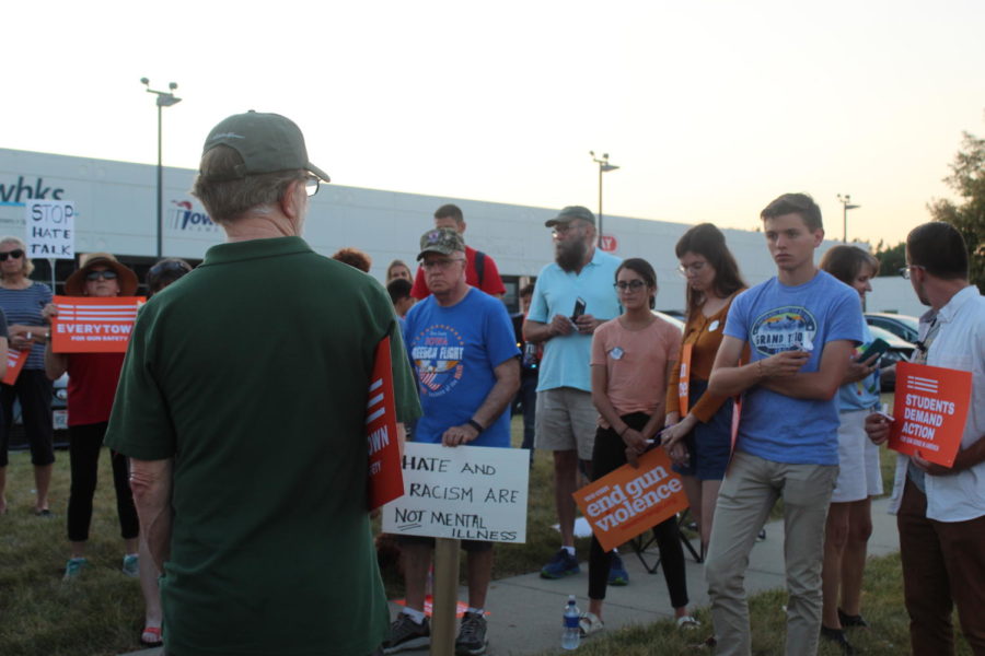 State Sen. Herman Quirmbach speaks to participants in the mass shootings vigil about his efforts to mandate background checks before gun purchases in Iowa and its failure in the Republican-controlled Legislature. The vigil, held outside Rep. Steve Kings office on Aug. 7, honored the victims of recent shootings in El Paso, Texas, and Dayton, Ohio.