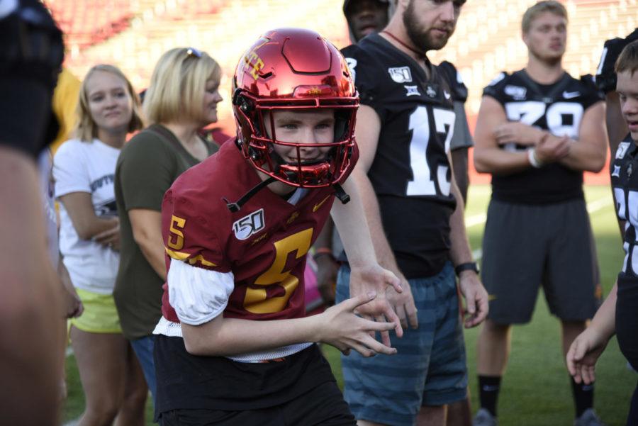 Kids were able to try on pieces of football equipment during Victory Day on the MidAmerican Energy Field at Jack Trice Stadium on Aug. 23. Victory Day gives local children with disabilities the opportunity to meet and play with members of the Iowa State football team.