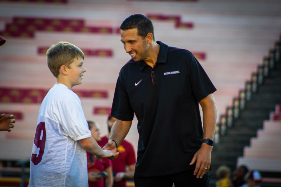 Iowa State football coach Matt Campbell shaking hands with a child during Victory Day Aug. 23 on the MidAmerican Energy Field at Jack Trice Stadium. Victory Day gives local children with disabilities the opportunity to meet and play with members of the Iowa State football team.