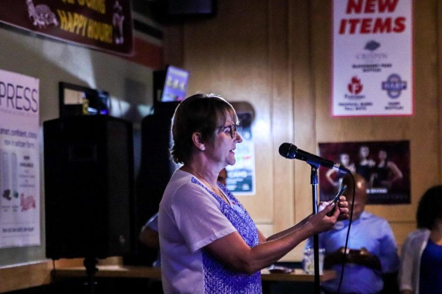 Madalyn Anderson, chair of the Story County Democrats, announces newly-elected State Rep. Ross Wilburn at Mother’s Pub on Aug 6. Wilburn won the seat with 97% of the vote.
