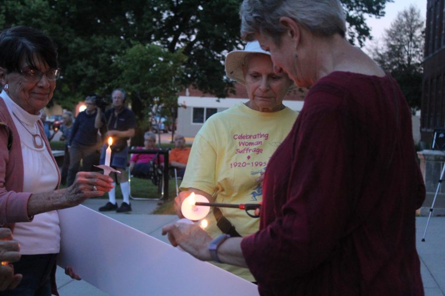 Ames community members begin lighting candles at the Shine a Light for Democracy Vigil on Aug. 6 at City Hall. The event took place on the 54th anniversary of the 1965 Voting Rights Acts passage and was meant to highlight the Supreme Court decision in Shelby County v. Holders elimination of the acts pre-clearance provision.