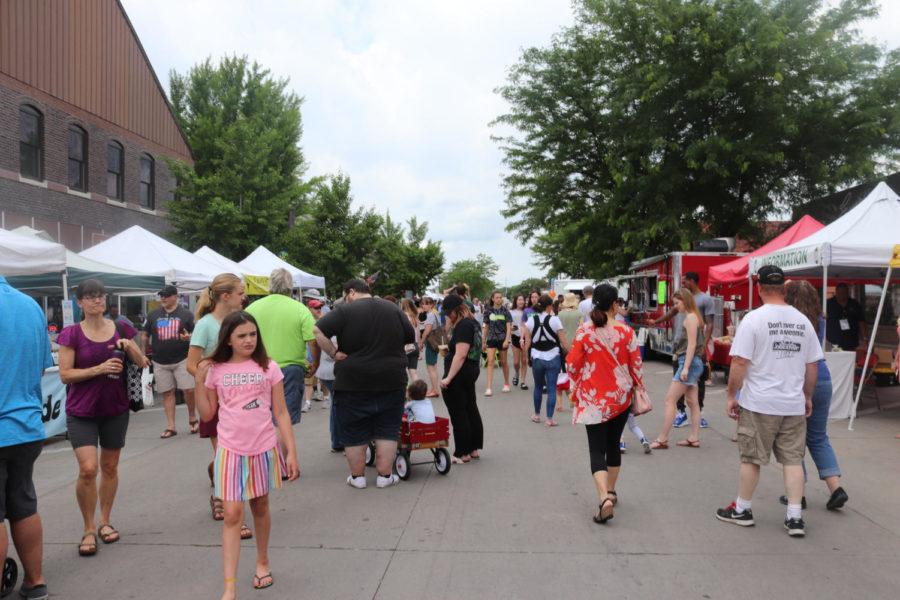 Patrons enjoy the Ames Main Street Farmers Market on June 15. The market and downtown Ames will host multiple presidential campaigns Saturday.