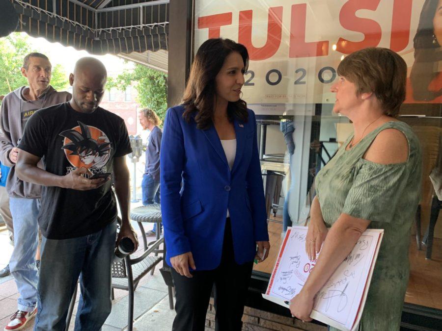 Rep.+Tulsi+Gabbard%2C+D-Hawaii%2C+speaks+with+Maddie+Anderson%2C+chair+of+the+Story+County+Democrats%2C+Aug.+10+outside+Cafe+Diem+in+Ames.