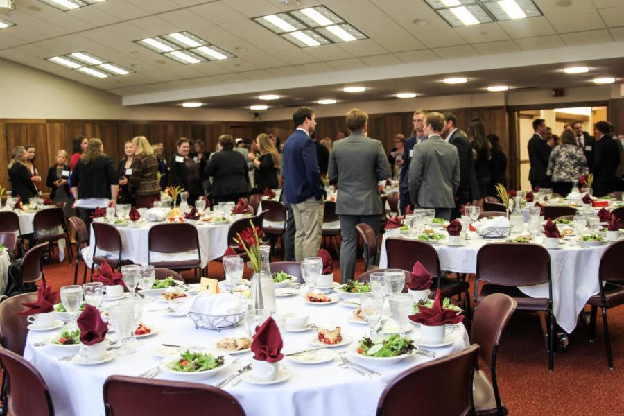 College of Agriculture and Life Sciences students converse with each other before the CALS etiquette dinner Tuesday in the Campanile Room of the Memorial Union.