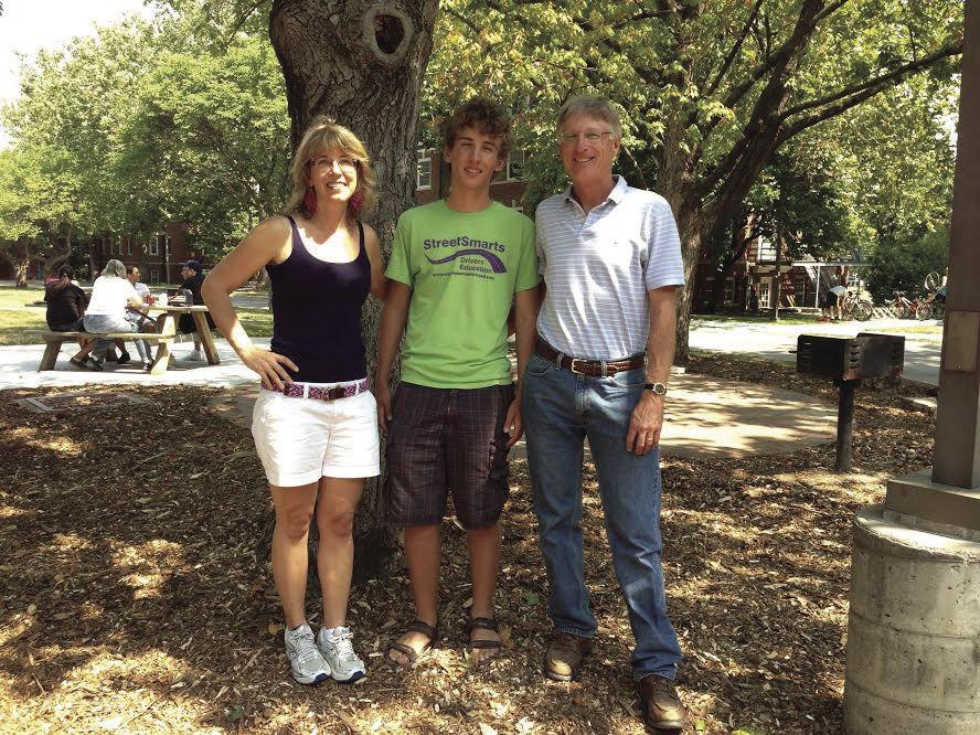Dane Schussler poses for a photo with his mother, Kathryn Schussler, and father, Jeffrey Schussler, on either side during a visit to Iowa State.