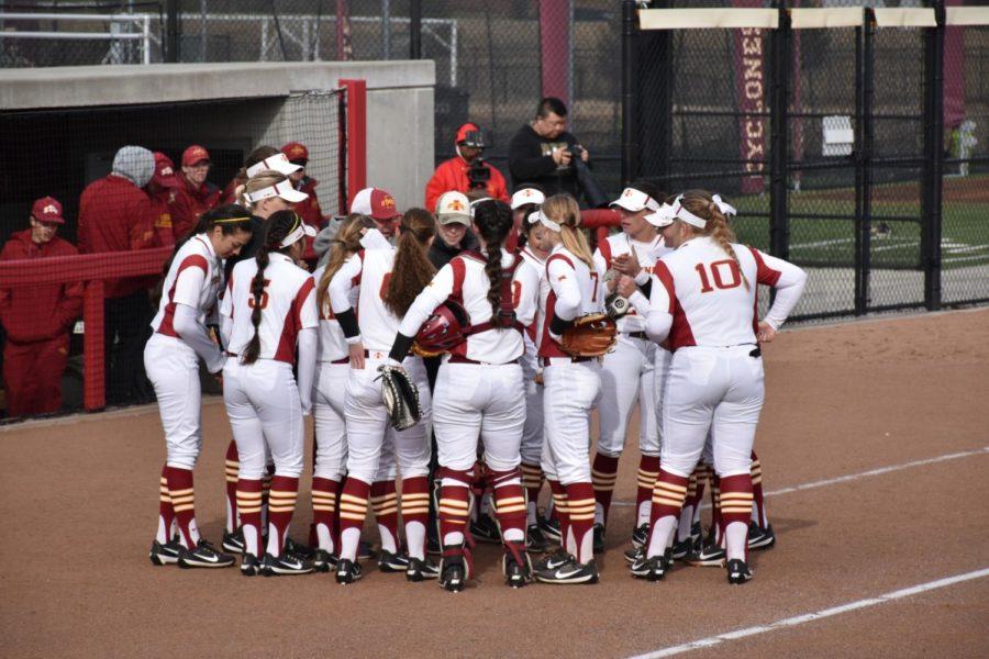 The Cyclone Softball team celebrates out of the dugout after three strikes.