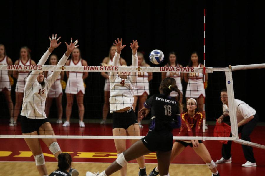 Middle blocker Candelaria Herrera (left) and outside hitter Josie Herbst (right) jump to block the ball during the Iowa State vs. Kansas State volleyball game Oct. 26 at Hilton Coliseum. The Cyclones won 3-1.