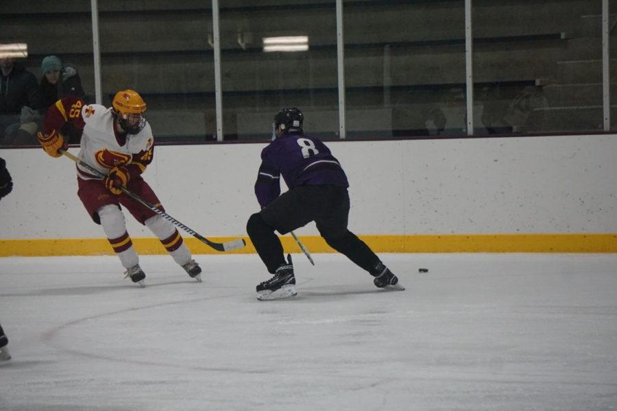 Then-freshman Patrick Berges fights for possession of the puck during the Cyclone Hockey versus McKendree University game Nov. 30. The Cyclones lost to the Bearcats 5-2.