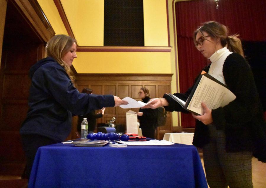 Cinestie Olson, then-freshman in public relations and communications, hands a resume to a Lifeserve representative at the Internship and Networking Fair Oct. 17 in the Great Hall. Lifeserve was one of the many booths at the fair searching for eager interns from Iowa State. 