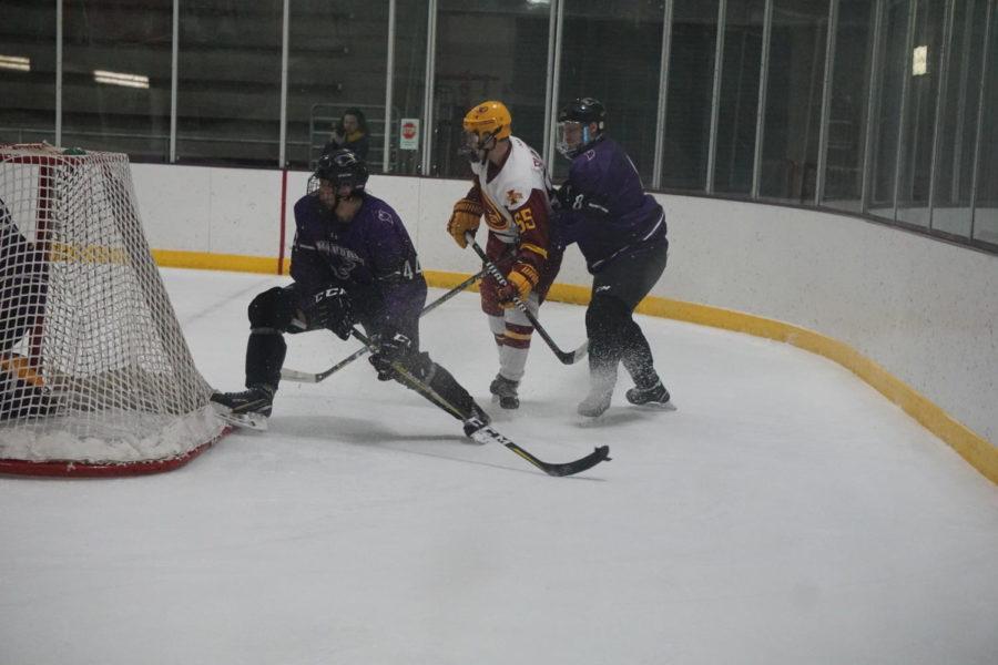Then-junior Brian Brunten fights for the puck during the Cyclone Hockey versus McKendree University game Nov. 30. The Cyclones lost to the Bearcats 5-2.