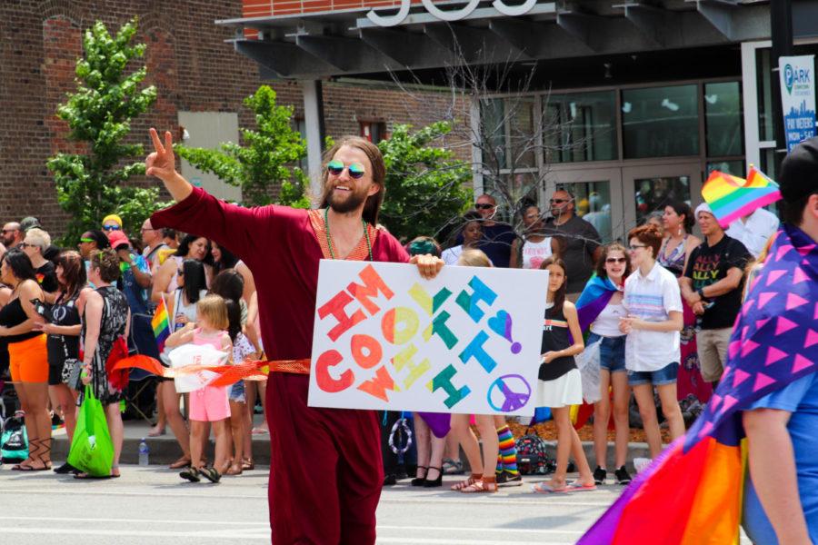 A parade participant dressed as Jesus holds a sign showing his support for the LGBTQIA+ community during the Des Monies Pride Parade on June 9. The parade started at the Iowa Capitol Building and traveled down Grand Avenue in the East Village. 