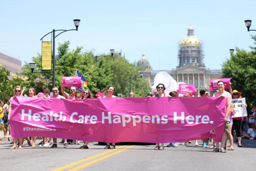 Planned Parenthood marches with their banner at the Capital City Pride Parade.
