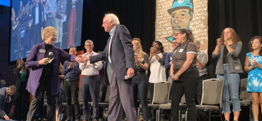 Sen. Bernie Sanders, I-Vt., greets a moderator at the Iowa Citizens for Community Improvement Action presidential forum Saturday in Des Moines. Sanders spoke about health care and tuition-free college during his time at the forum.