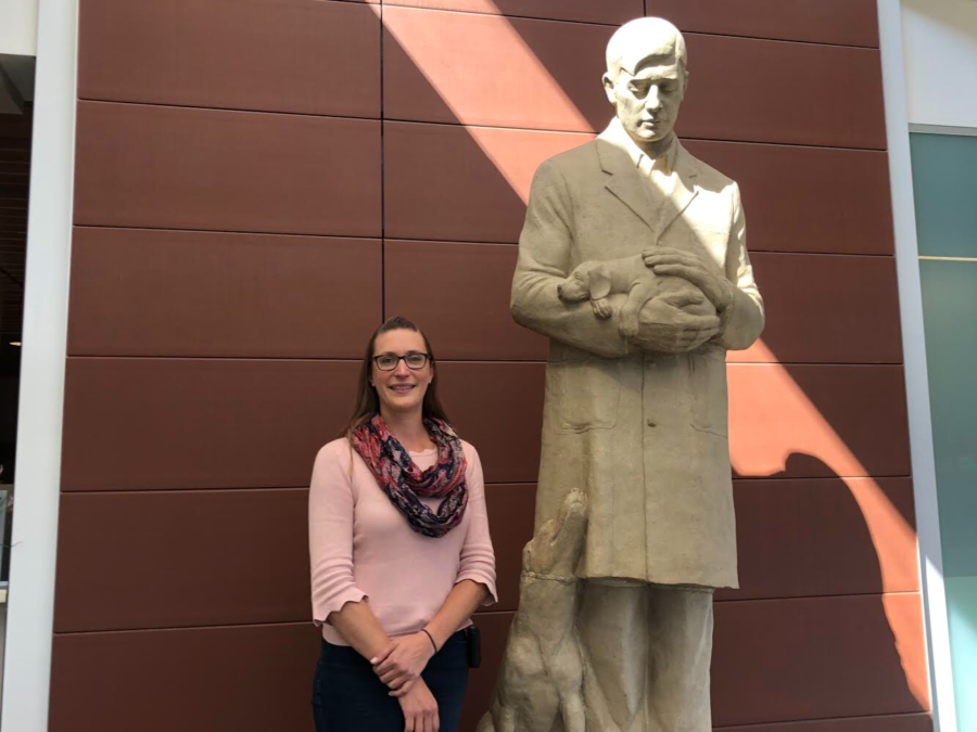 Jessica Ward, assistant professor in the veterinary clinical sciences department with a specialty in cardiology, stands next to the The Gentle Doctor sculpture.
