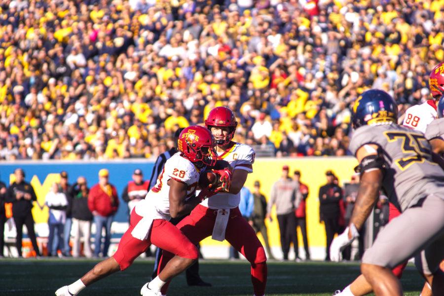 Brock Purdy hands the ball off to Breece Hall in Iowa States away game against West Virginia on Oct. 12. The Cyclones beat the Mountaineers 38-14.