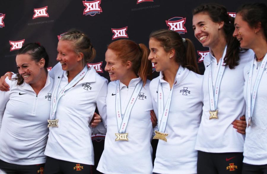 Iowa State distance runners (left to right) Abby Caldwell, Cailie Logue, Anne Frisbie, Amanda Vestri, Kelly Naumann and Larkin Chapman pose for their friends after being awarded medals for placing within the top 15 during the 2018 Big 12 Cross Country Championships on Oct. 26, 2018, at Iowa State. The women’s team placed first overall with a score of 35.