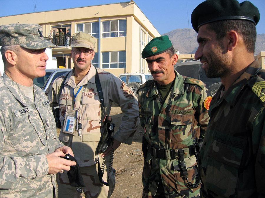 American and Afghan service members speak in Kabul, Afghanistan.