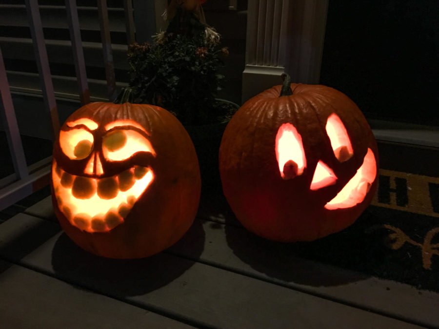A pair of Jack-O-Lanterns sit on a porch in Copper Beech, lighting up the night as Halloween quickly approaches.