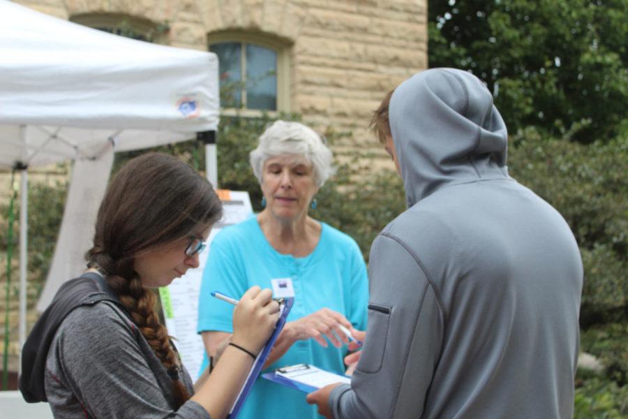 Cheryl Binzen, volunteer for the League of Women Voters, talks to students about voting at Women’s Equality Day on Aug. 26, 2016, outside Catt Hall.