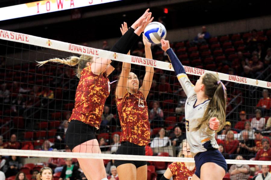 Avery+Rhodes+and+Eleanor+Holthaus+block+West+Virginias+hit.+Iowa+States+volleyball+team+faced+West+Virginia+on+Nov.+6.+Iowa+State+won+3-0.